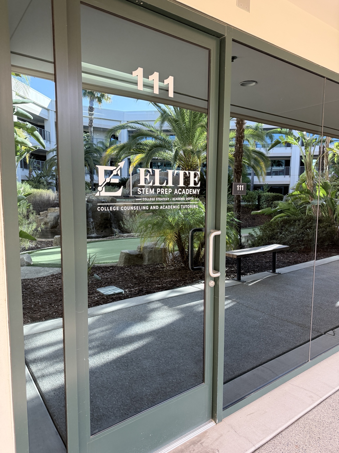 Elite STEM Prep Academy logo on Suite 111 entrance